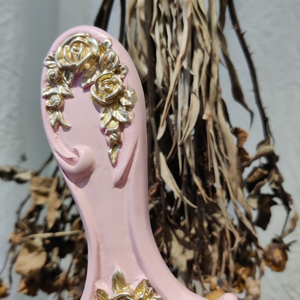 Ornate handheld vanity mirror frame detail