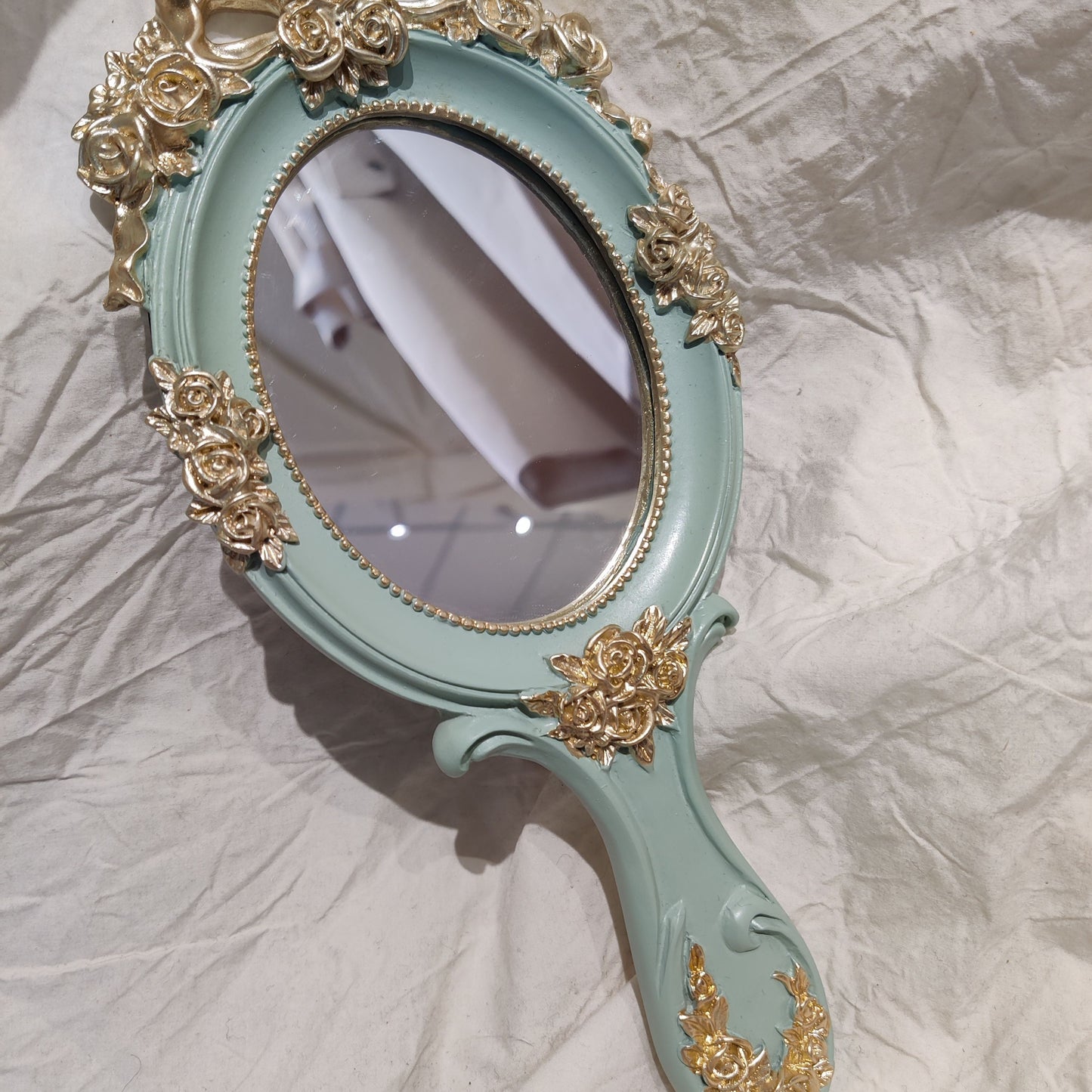 Decorative vanity mirror handle detail