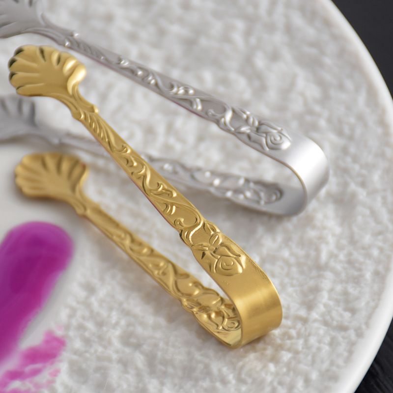 Decorative small serving tongs close view